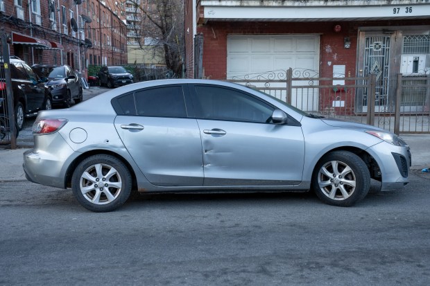 A bullet hole is seen here in this silver Mazda 3 sedan after Jairo Javier Vinces-Cobena was fatally shot on 55th Ave. in Queens on Friday, March 13, 2026. (Theodore Parisienne / New York Daily News)