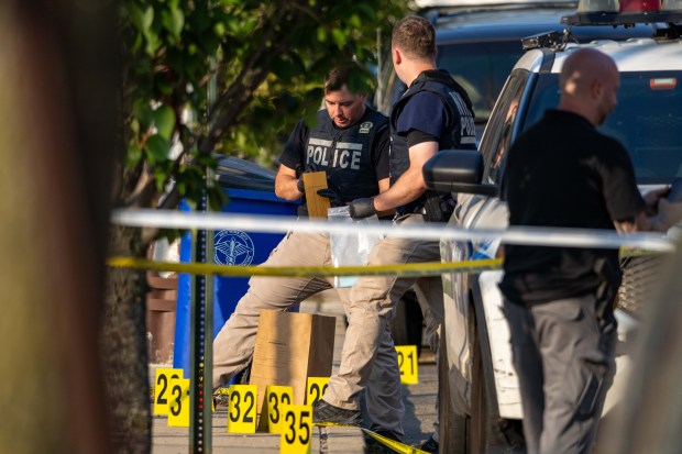NYPD officers shot and wounded armed suspect Keegan Thompson at a Queens home on Ocean Crest Blvd. near Hartman Ln. in Far Rockaway, where two of the suspect's relatives were found dead and a fire was started on Saturday, July 25, 2026. (Theodore Parisienne / New York Daily News)