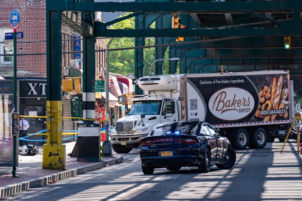 Police investigate the fatal crash on Roosevelt Ave. Thursday morning.