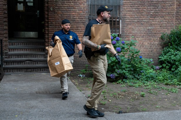 Police investigate after a man was found with a gunshot wound to the eye inside an apartment on Frederick Douglass Boulevard and Macombs Place in Manhattan early Saturday.