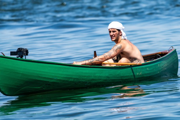 A canoeing photographer enjoys a cold one during the Sail4th 250 Tall Ships Parade in New York Harbor on July 4, 2026. (Theodore Parisienne / New York Daily News)