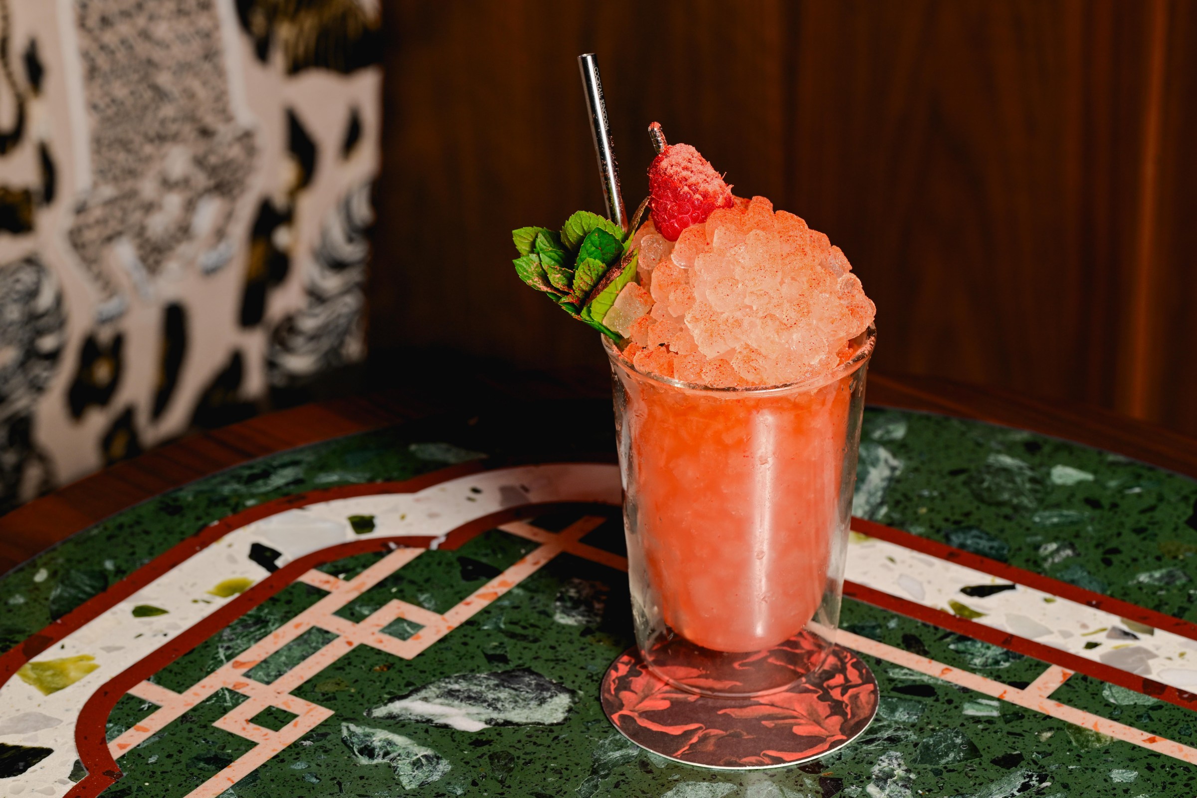 A cocktail with crushed ice and bright red liquid.