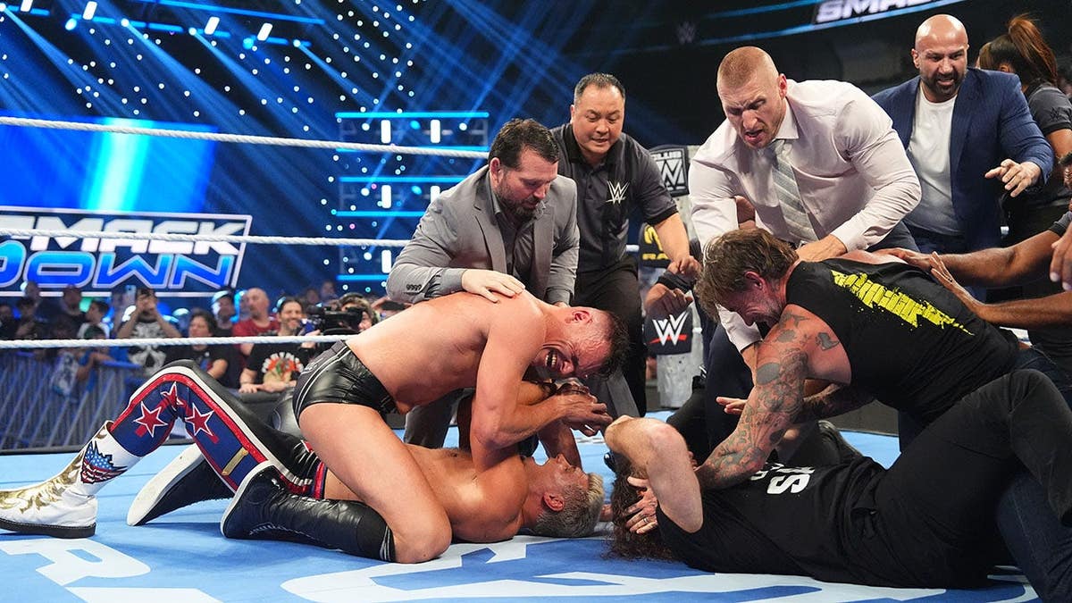 Gunther, Cody Rhodes, Sami Zayn and CM Punk brawl inside an arena.