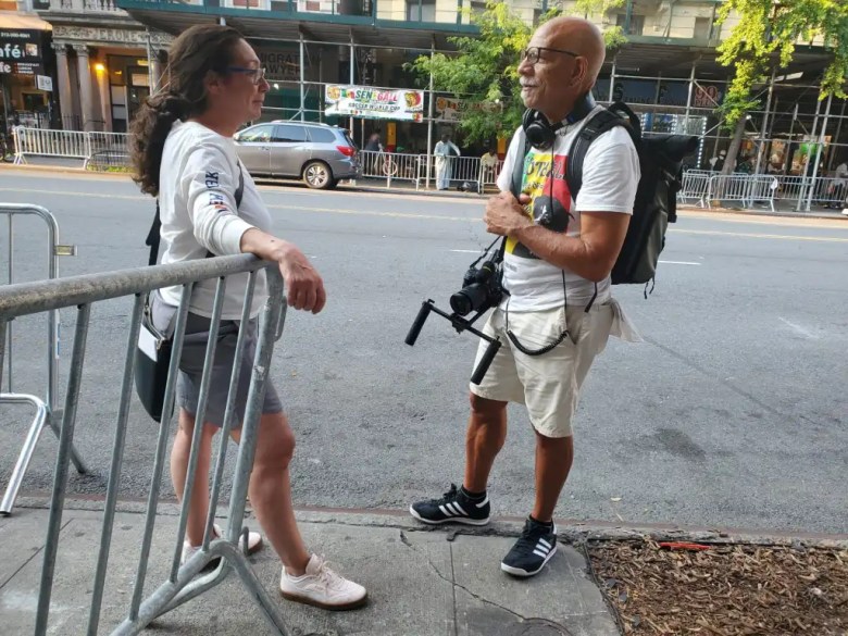 Victor Sanchez chats with Michelle Londino about the Sengal match and the barricades in Little Senegal that day. Credit: Ambar Castillo / Epicenter NYC