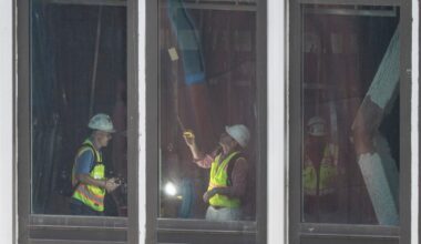 People inspect a buckled support beam inside 235 East 42nd Street, Wednesday, July 8, 2026, in New York.