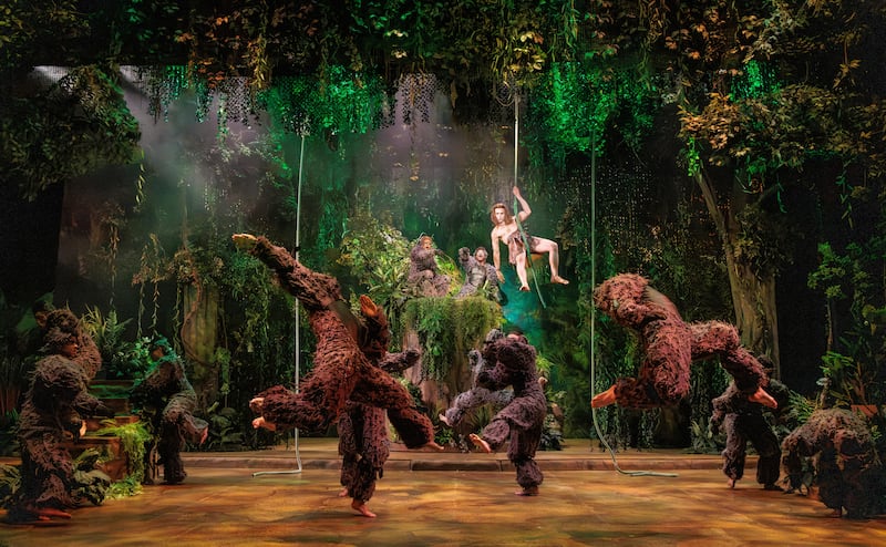 Dean Cestari as Tarzan (center, on vine) with the Tribe in The REV Theatre Company’s production of “Tarzan.”