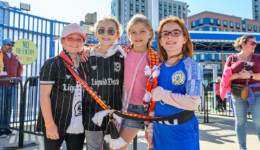 Young fans at a Brooklyn FC match cheering for their team