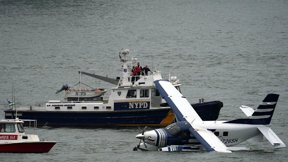 Emergency crews surround a seaplane after it made a hard landing in New York City's East River.
