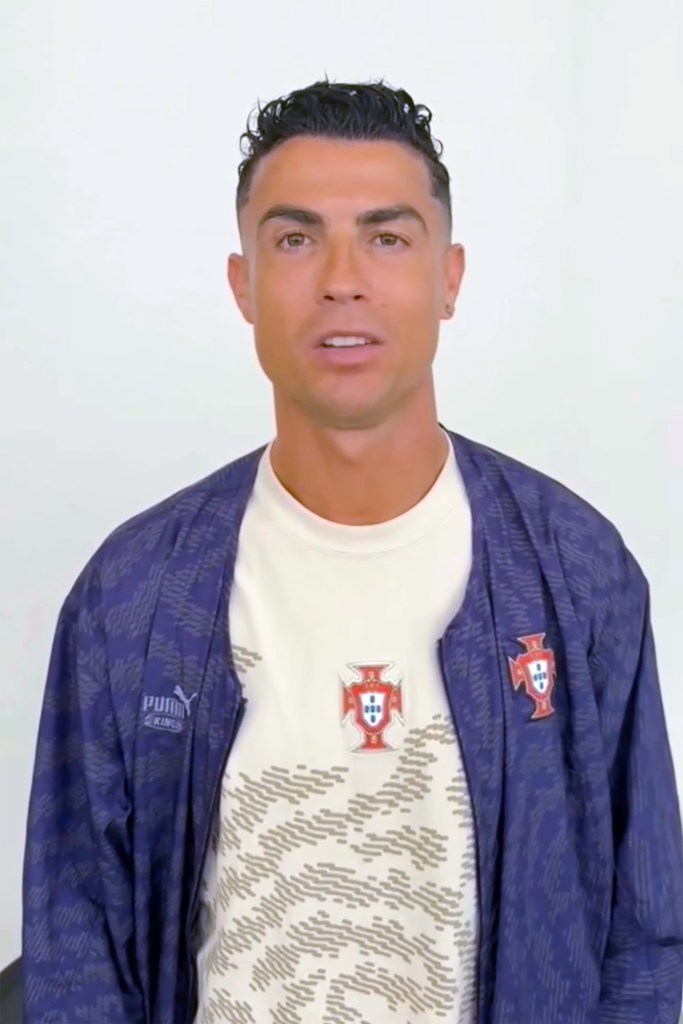 Headshot of Cristiano Ronaldo in a blue jacket over a white shirt with a Portuguese crest.