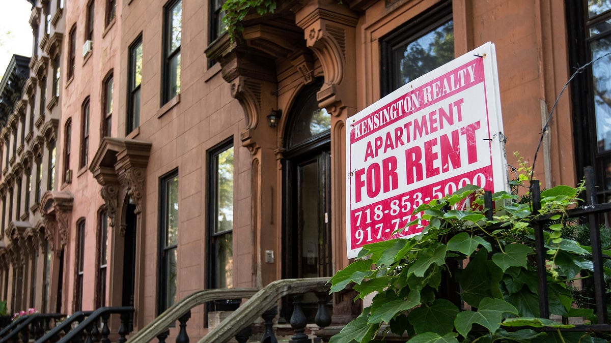 A sign advertises an apartment for rent along a row of brownstone townhouses in the Fort Greene neighborhood of Brooklyn.