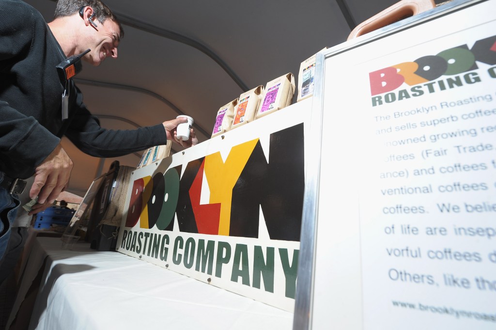 An attendee getting a cup of coffee from The Brooklyn Roasting Company booth.
