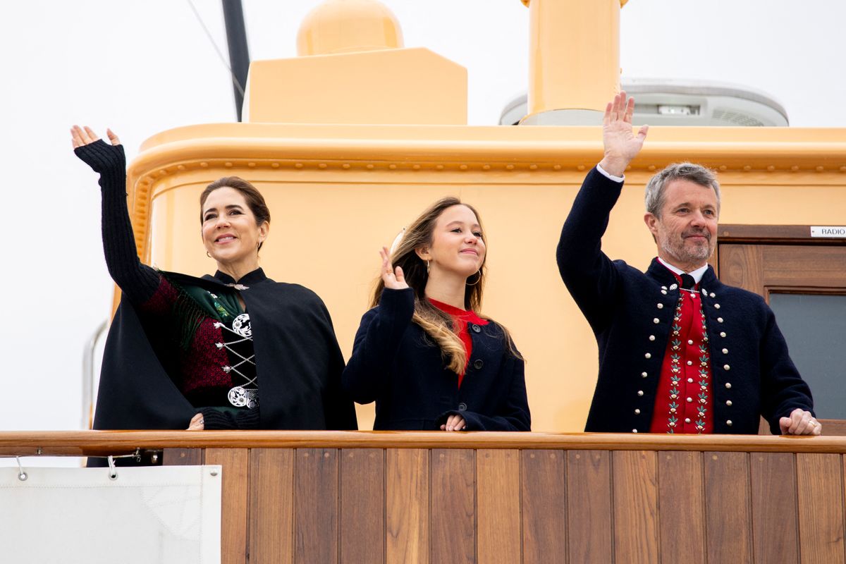 Denmark's King Frederik X, Queen Mary, and their daughter Princess Josephine wave upon their arrival with the Royal Yacht  in Torshavn on the Faroe Islands on June 11, 2025.