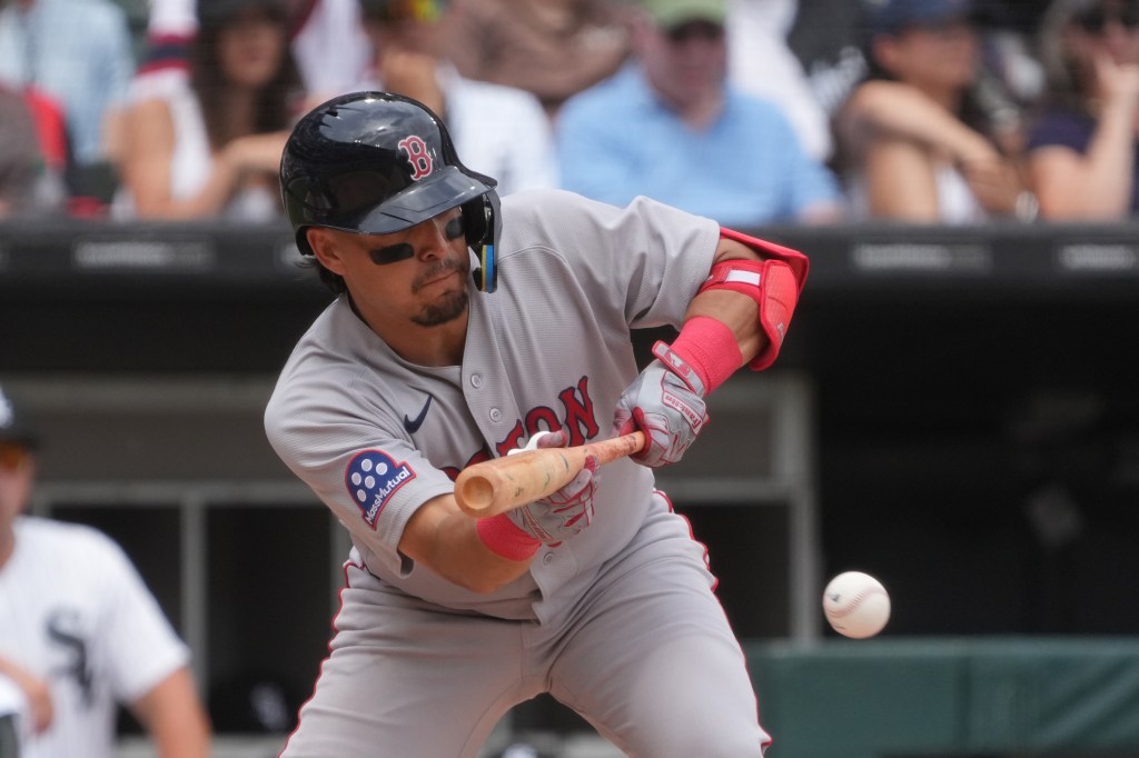 Boston Red Sox second baseman Anthony Seigler bunts a baseball.