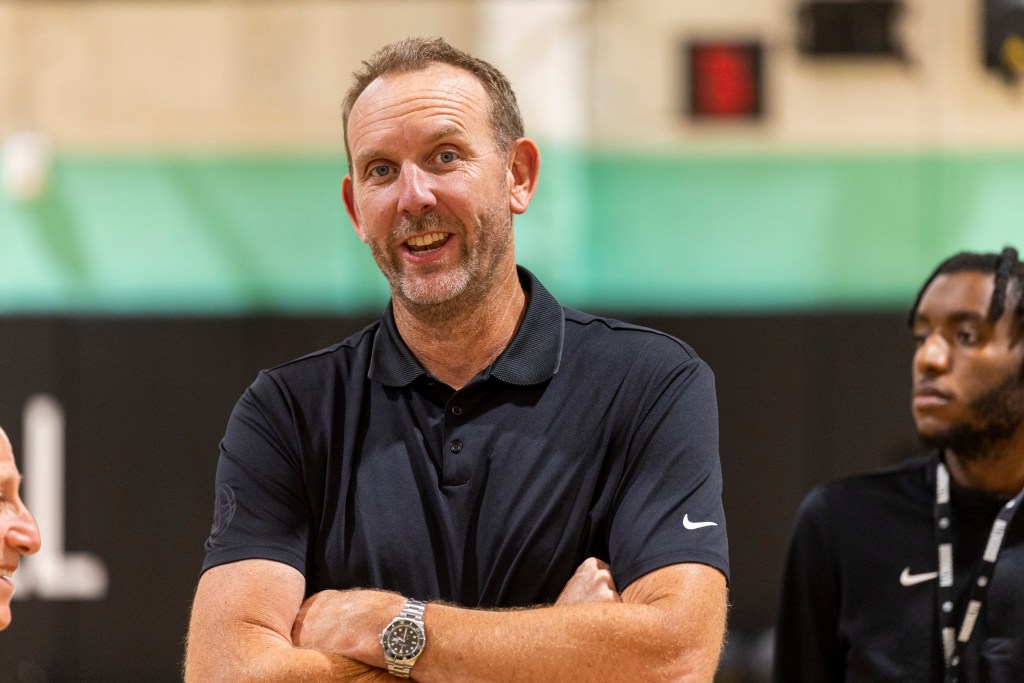 Brooklyn Nets GM Sean Marks smiling during an NBA Draft press conference.