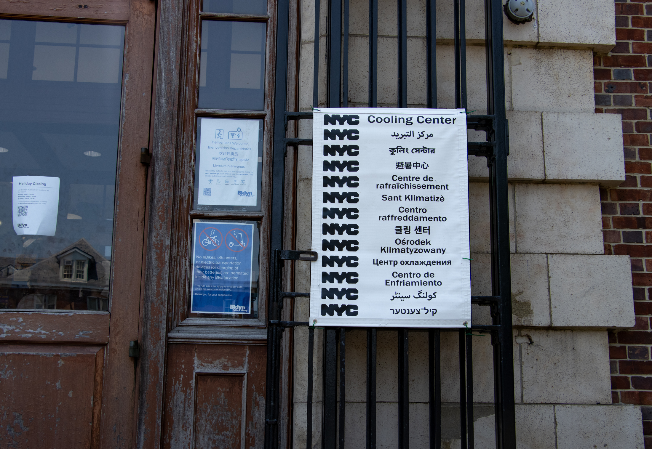 cooling center sign in multiple languages outside of a library