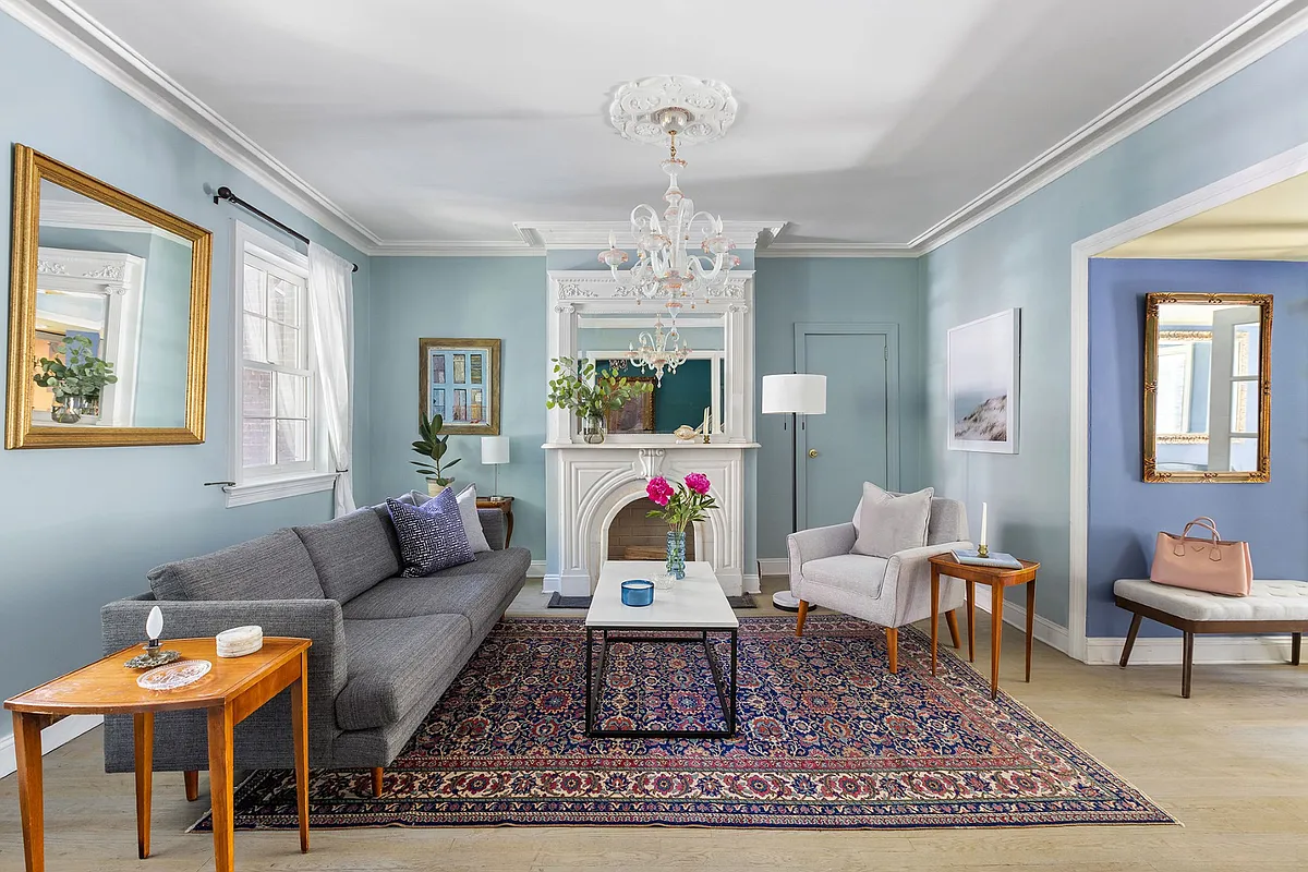 living room with blue walls and a mantel