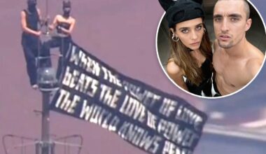 Kissing daredevils scale Empire State Building antenna, hanging flag 1,454 feet over NYC with cringe message