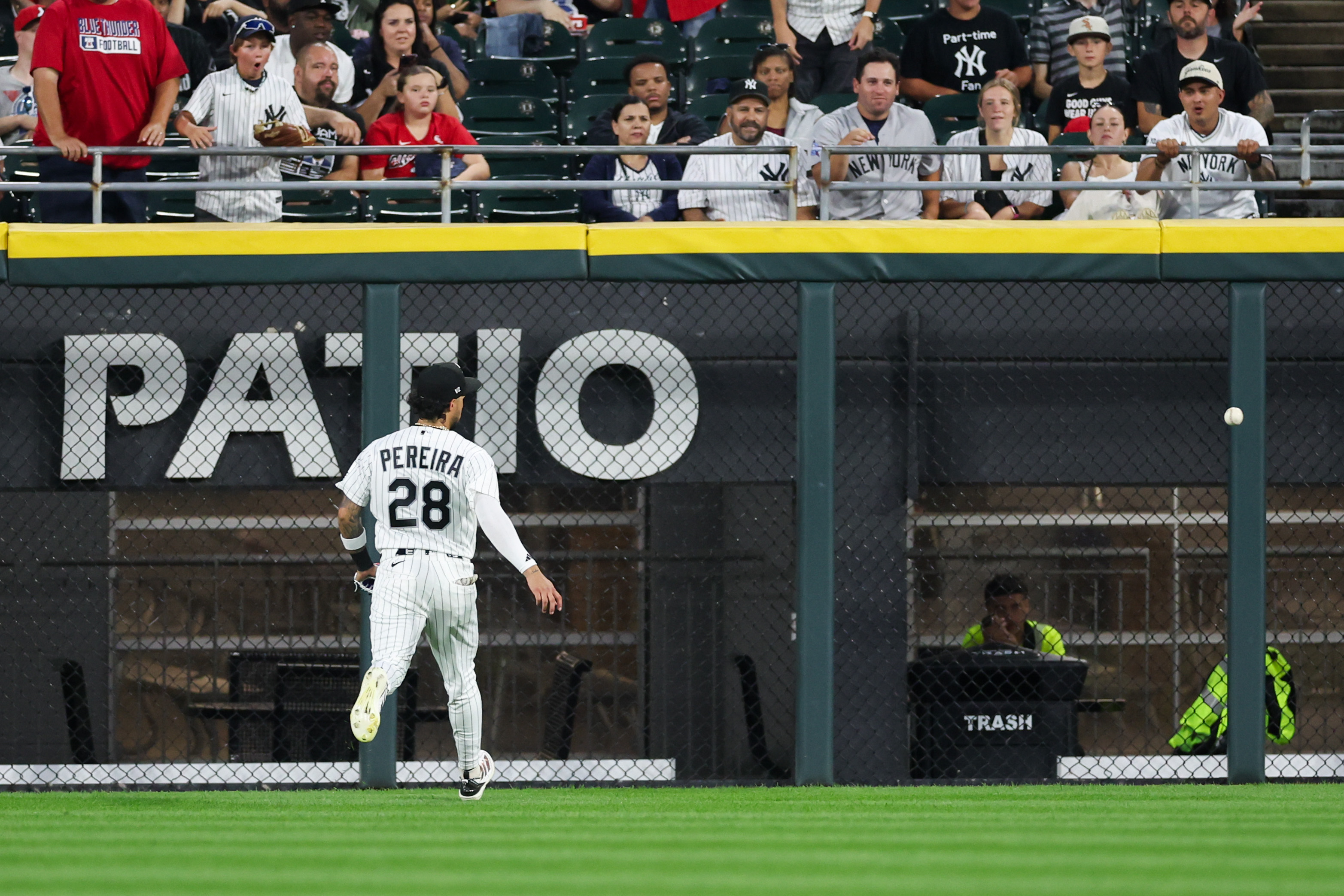 White Sox bench coach Walker McKinven (28) chases a two RBI double ball from Yankees second baseman Jazz Chisholm Jr. (13) during the fourth inning at Rate Field July 27, 2026 in Chicago. (Armando L. Sanchez/Chicago Tribune)