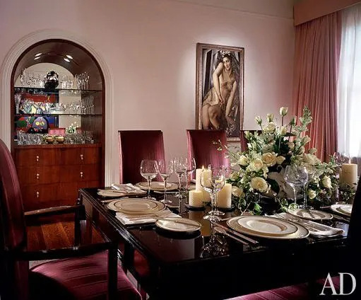Christopher Ciccone designed a built-in mahogany buffet to complement the circa-1930 dining table and chairs by Jean Pascaud. On the wall is Nana de Herrera, 1930, by de Lempicka. Chair and silk moiré drapery fabrics by André Bon.