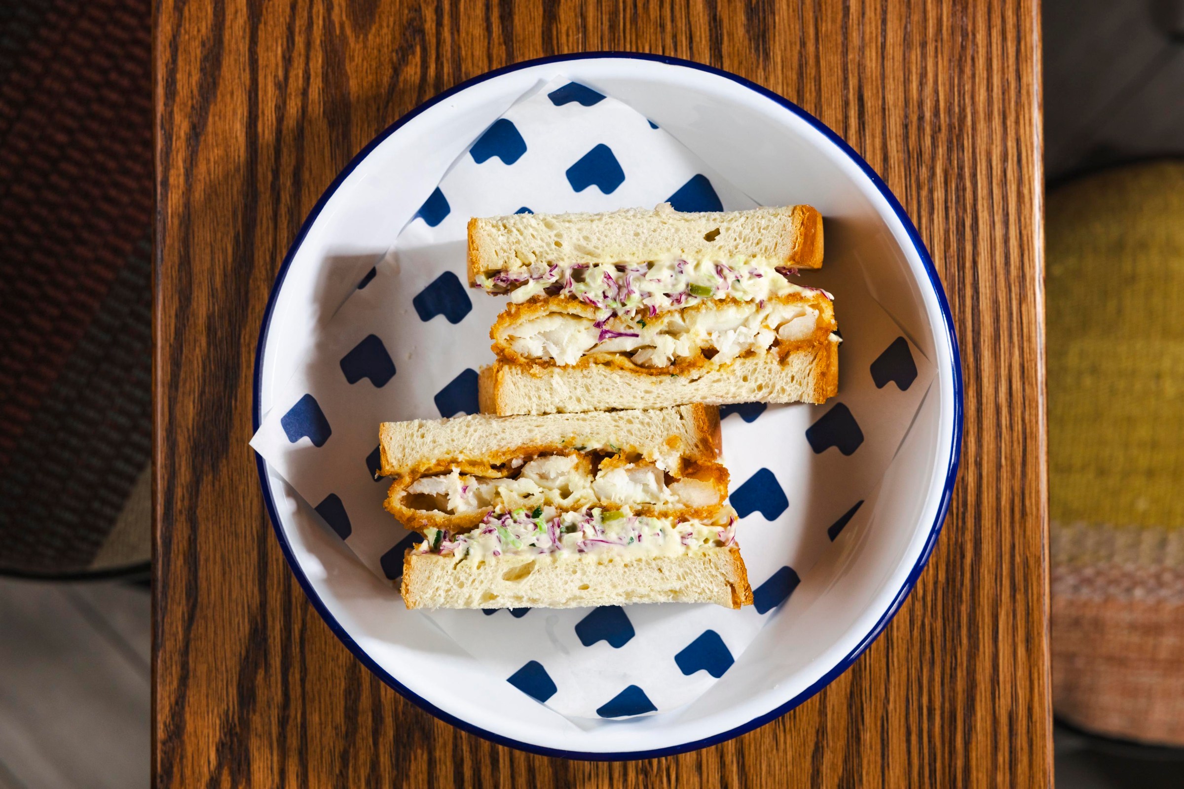 Two sandwich halves vertically on a palte.