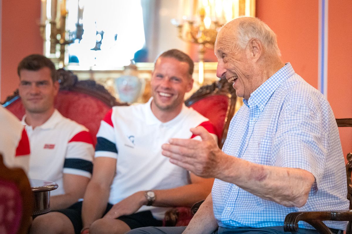 King Harald V of Norway speaks with Members of Norway's national football team including Norway's goalkeeper #01 Orjan Nyland 