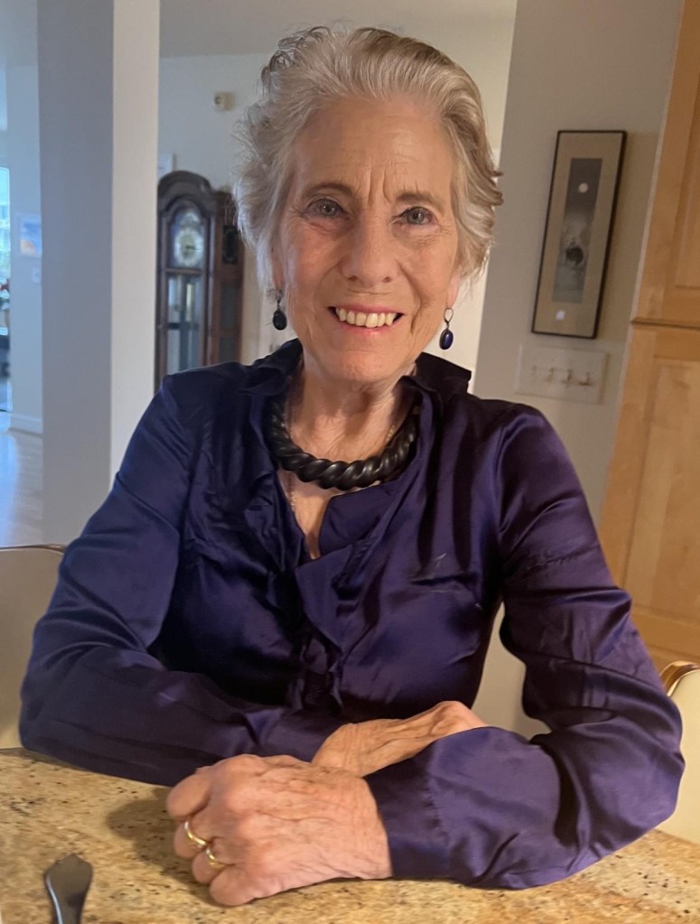 Elizabeth Childs-Johnson in her home in a purple shirt. 