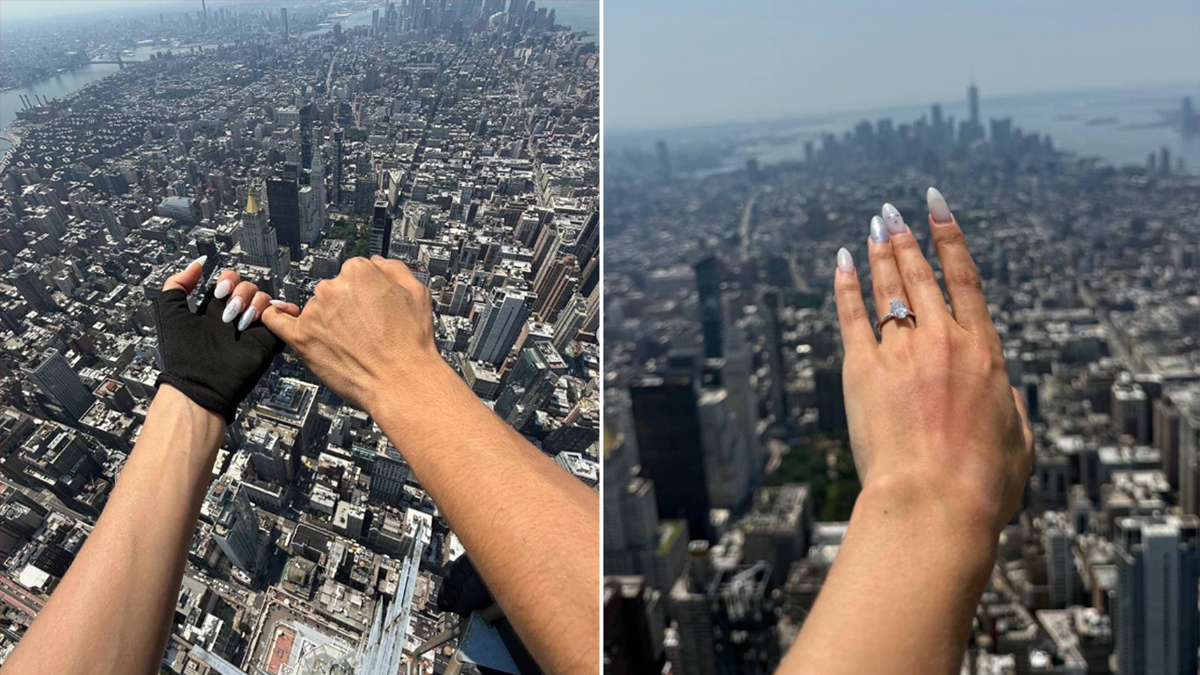 close up of couple's hands with engagement ring with view of New York City