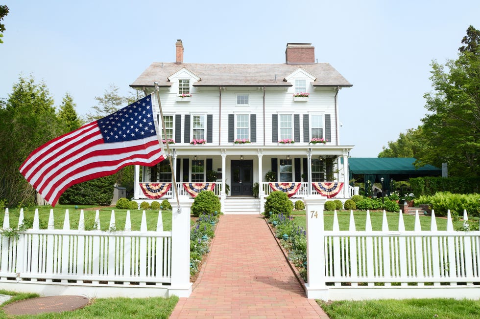 An American flag waves in the wind in front of The Hedges Inn in East Hampton An American flag waves in the wind in front of The Hedges Inn in East Hampton