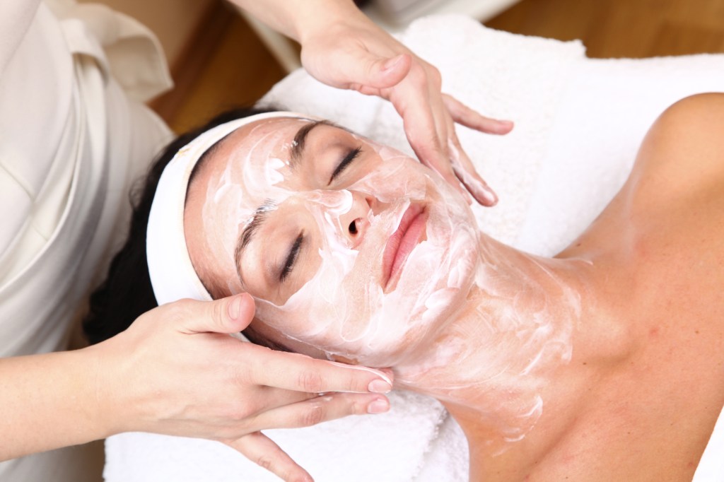 A stock image of a woman getting a facial in a spa. 
