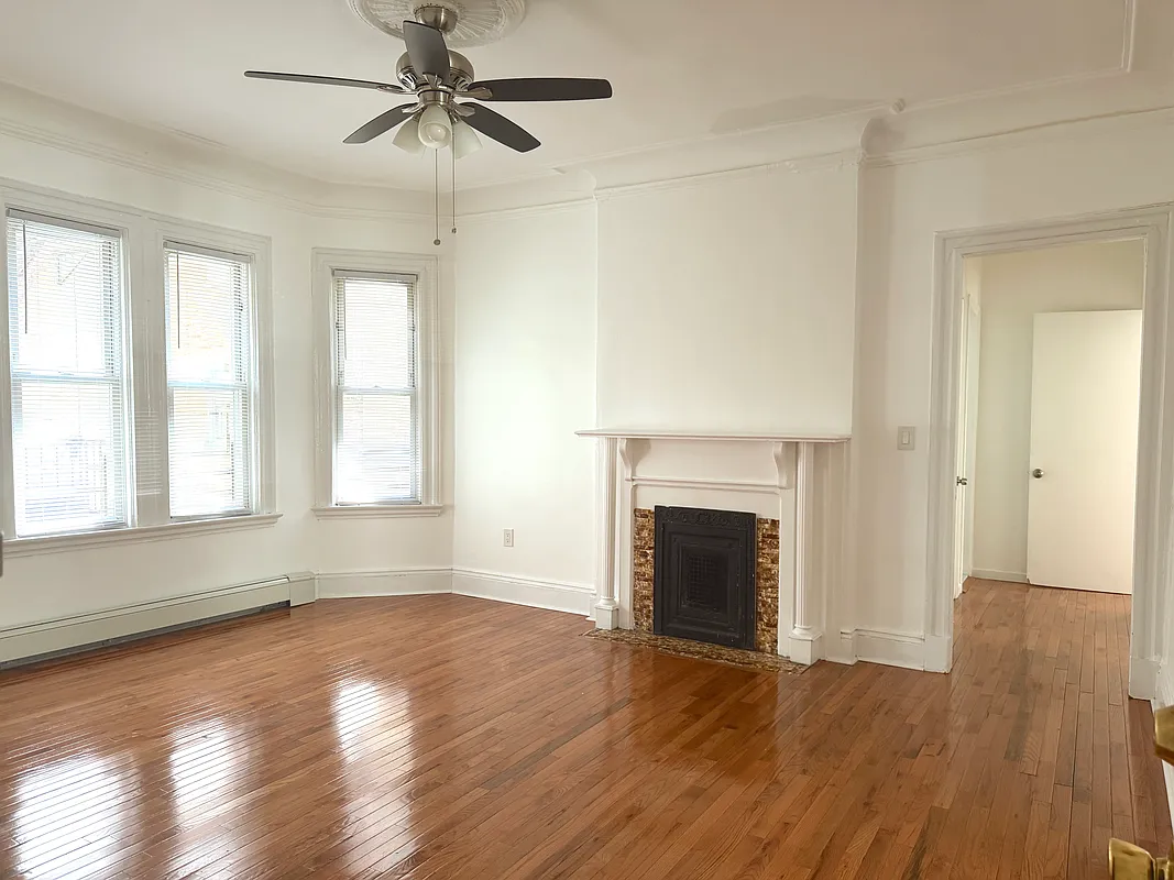 flatbush living room with mantel, bay window, ceiling fan