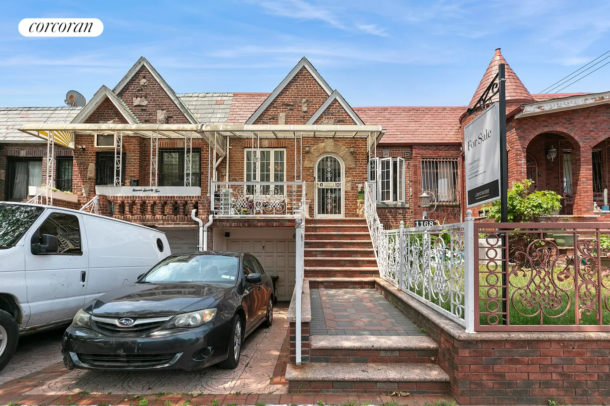 brick row house with parking in front