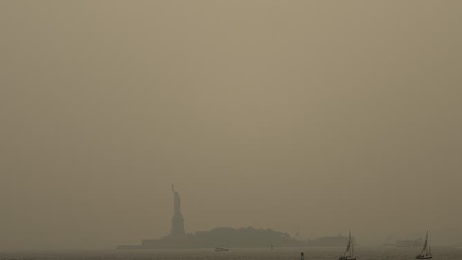 NEW YORK, NEW YORK - JULY 16: Haze from Canadian wildfires blankets the Statue of Liberty as seen from a Staten Island Ferry on July 16, 2026 in New York City. Much of the East Coast and Canada is under an Air Quality Health Advisory as the Canadian and Great Lakes wildfire smoke gradually moves through the area, creating a thick haze in the heat. The region is experiencing temperatures with heat indexes over 100 degrees as it confronts another heat wave.Ahead Of World Cup Final, NYC Metro Area Under Smoky Skies Due To Canadian Wildfires.