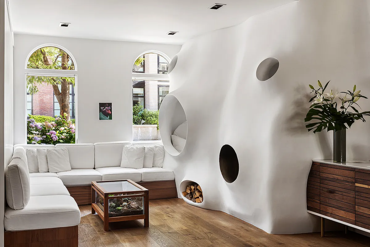 living room with sculptural pod with reading nook