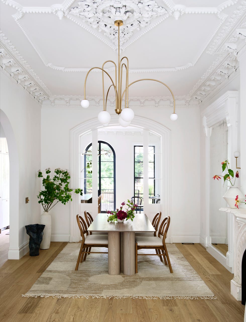 a dining room with a chandelier over the dining table