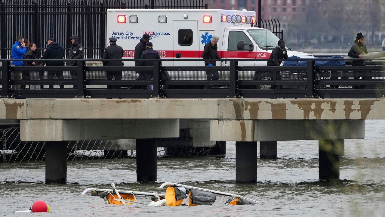 Emergency personnel respond to a helicopter crash on the Hudson River, April 10, 2025, in Jersey City, N.J.