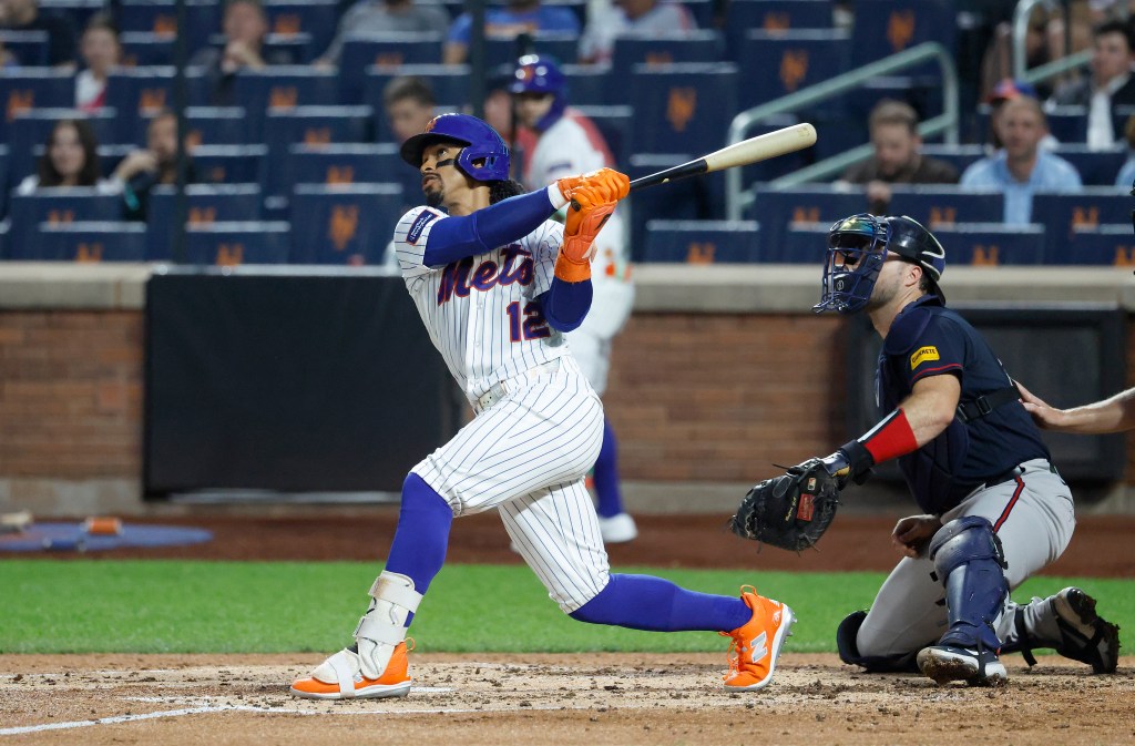 New York Mets shortstop Francisco Lindor (12) hits a two-run home run against the Atlanta Braves.
