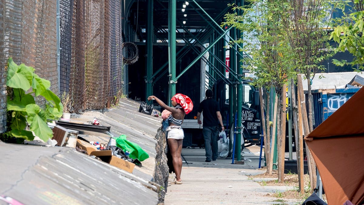 Woman near homeless encampment in NYC