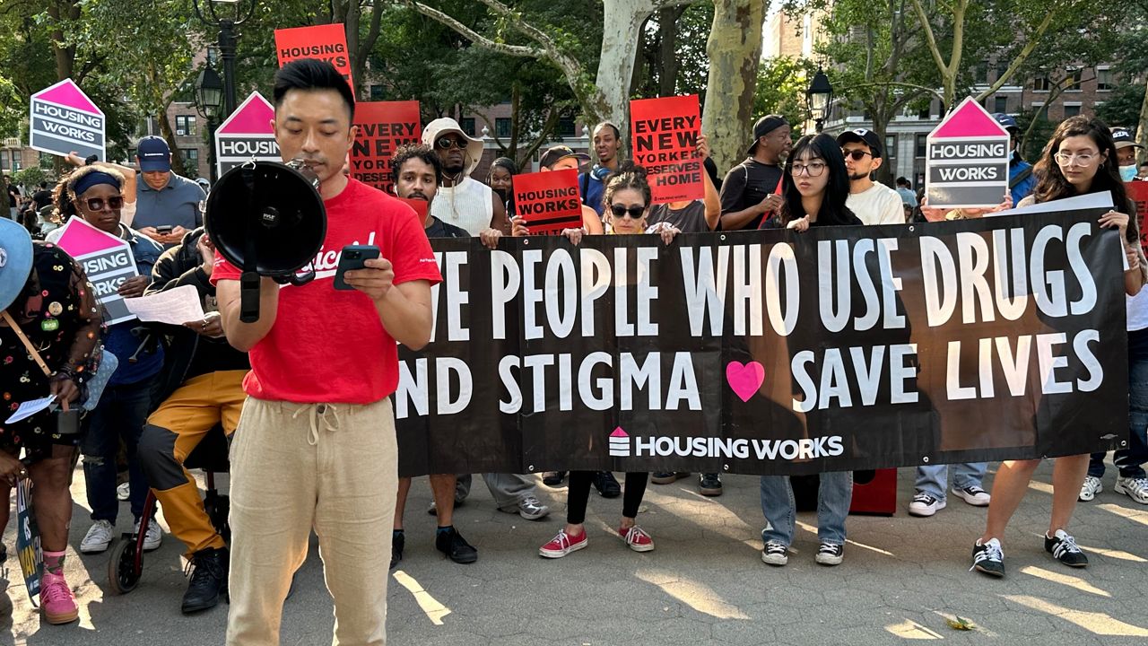 The debate was playing out along the busy West Side Highway, where a small encampment sits across from the Intrepid. (Spectrum News NY1/Tyler Buesching)