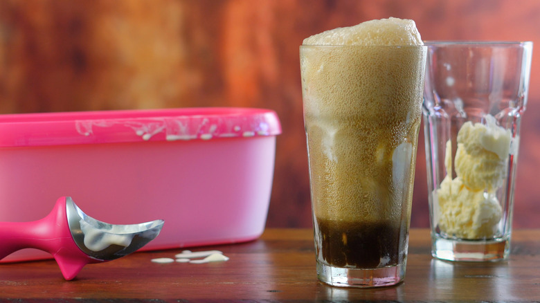 Ingredients for making an old fashioned soda at home with vanilla ice cream in a cup