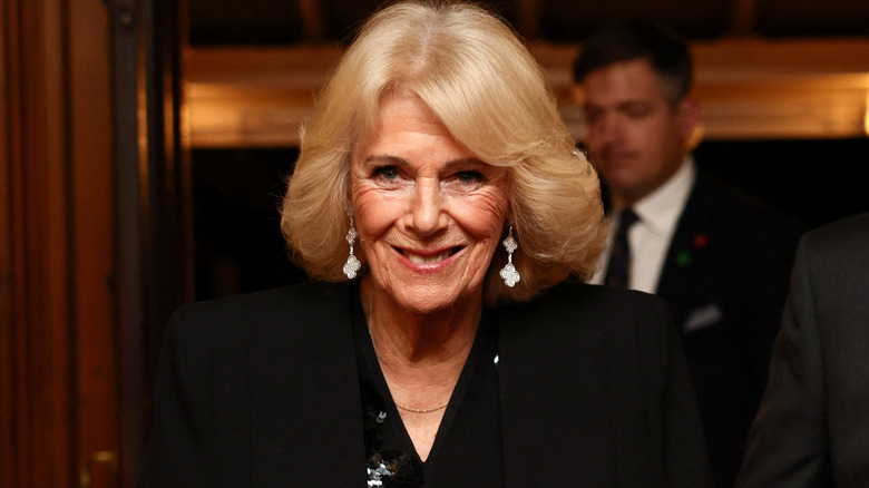 Queen Camilla smiles during an event in 2025