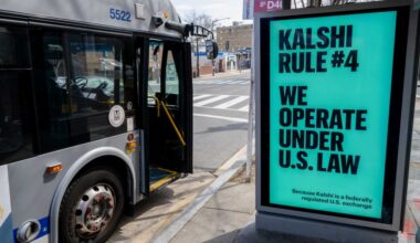 A Kalshi advertisement at a bus stop displays the text, "We operate under US law because Kalshi is a federally regulated US exchange."