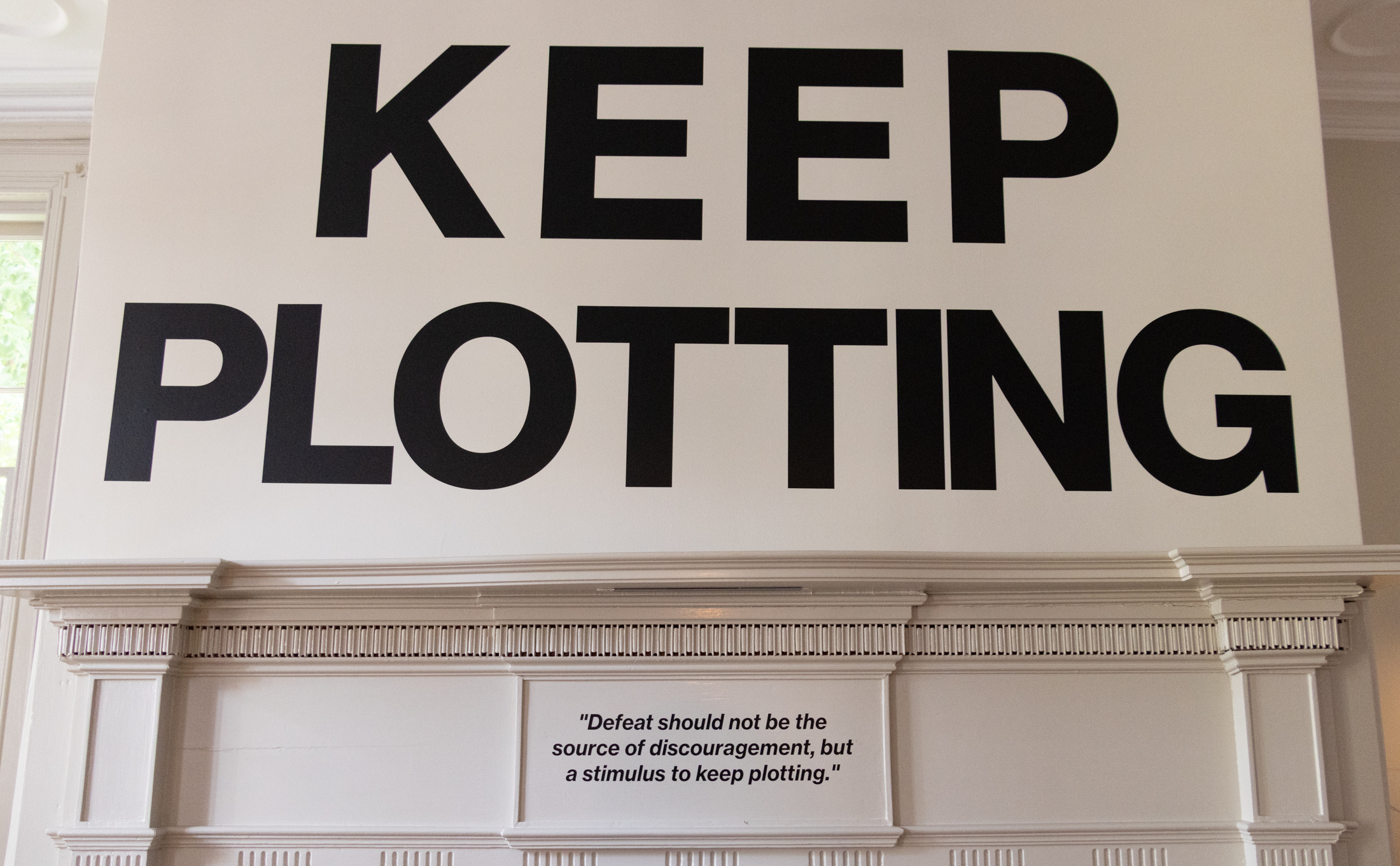 "keep plotting" in letters above the mantel