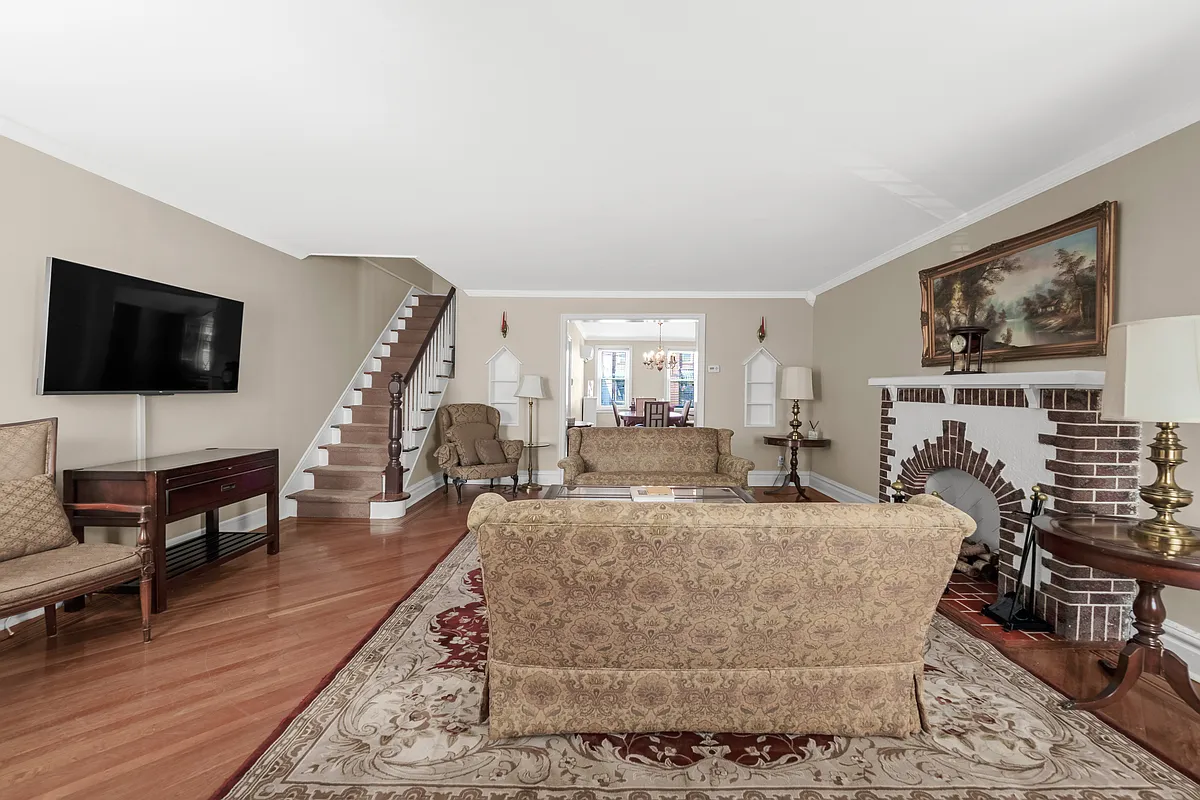 living room with brock mantel, wood floor