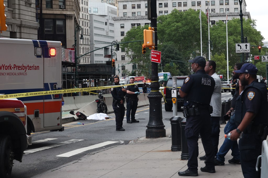 Emergency services and police at the scene of a fatal e-bike accident.
