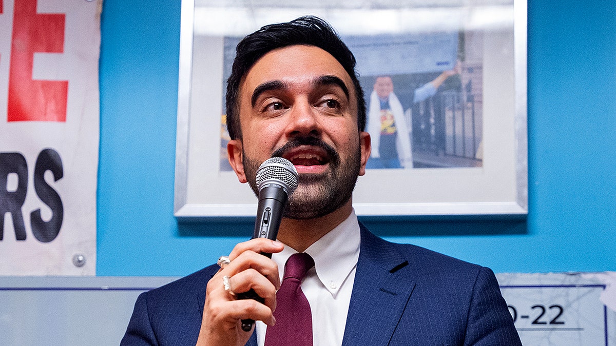 Zohran Mamdani speaking at a podium during a Ramadan Iftar event.