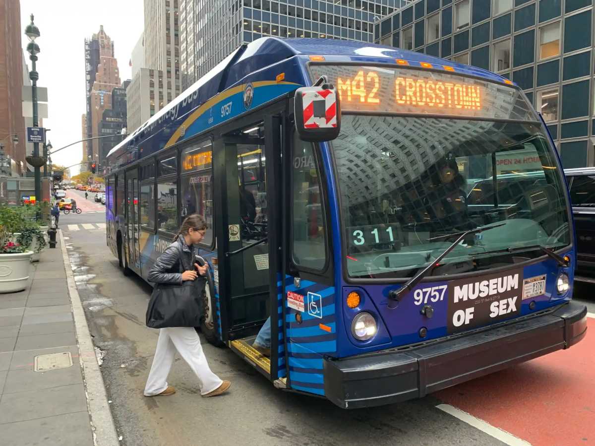 rider boarding M42 bus along 42nd Street in Midtown