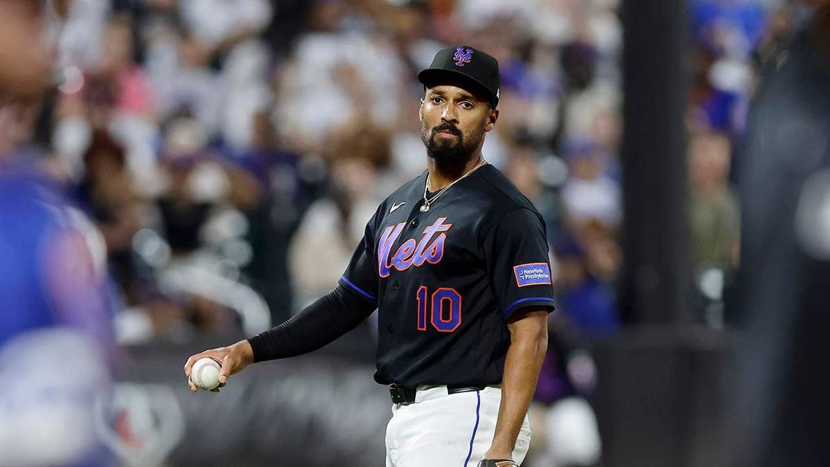Marcus Semien of the New York Mets holding a baseball at Citi Field.
