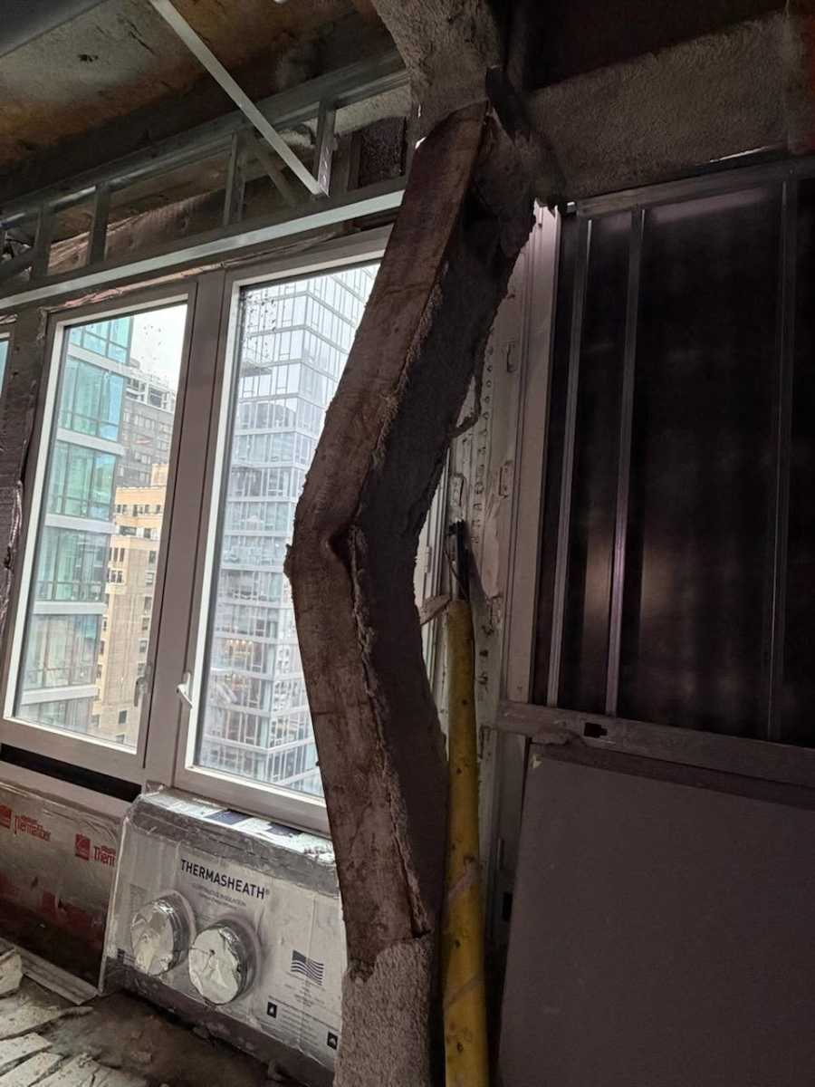 buckled steel beam inside Midtown building