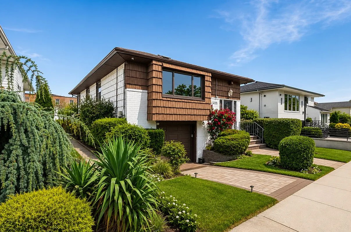 house with shingles and brick and parking in front
