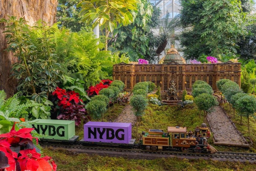 Miniature train and botanical replica at New York Botanical Garden exhibit.